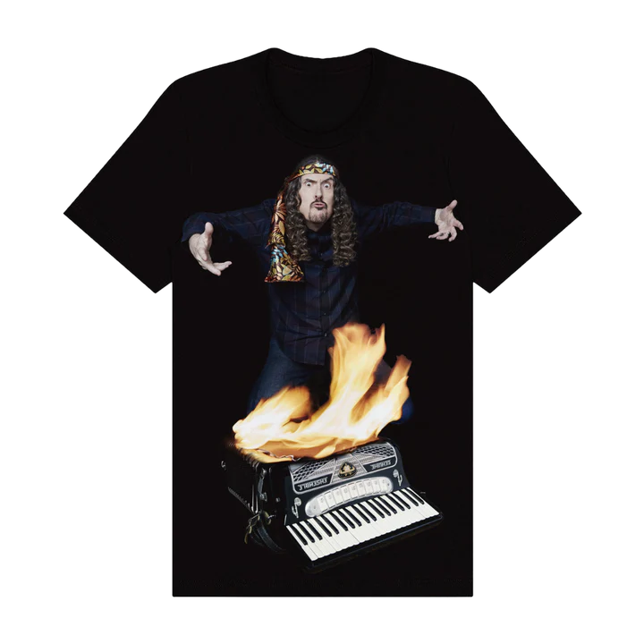 Black t-shirt with a graphic of a person with long hair playing an accordion on fire.