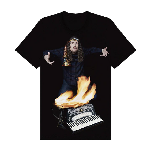 Black t-shirt with a graphic of a person with long hair playing an accordion on fire.