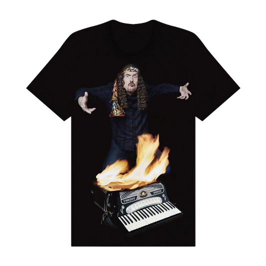 Black t-shirt with a graphic of a person with long hair playing an accordion on fire.