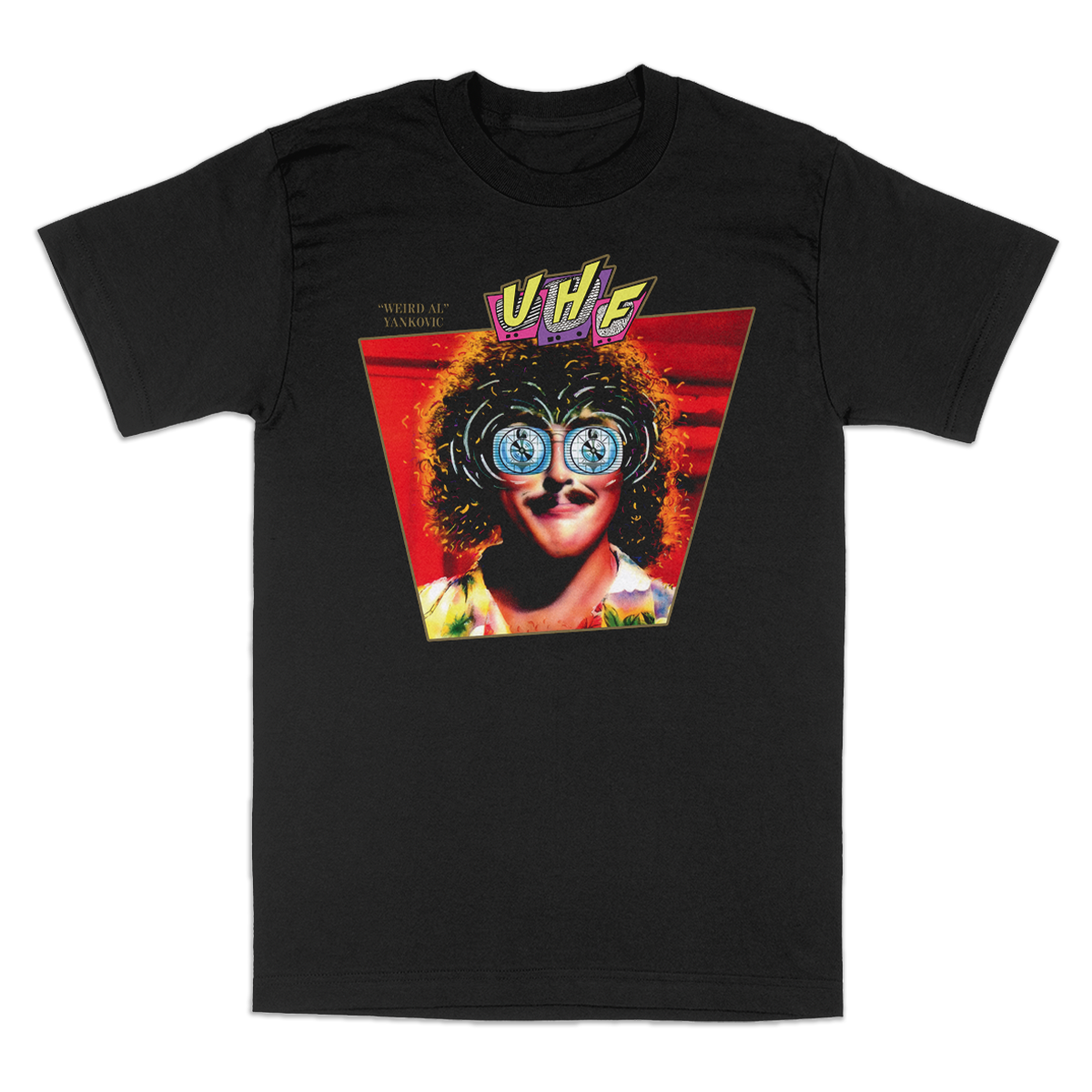 A black short-sleeve graphic t-shirt featuring "Weird Al" Yankovic with round glasses. The graphic shows a stylized portrait of a person with curly hair and blue-tinted glasses inside a red triangle, with the 'UHF' logo above.